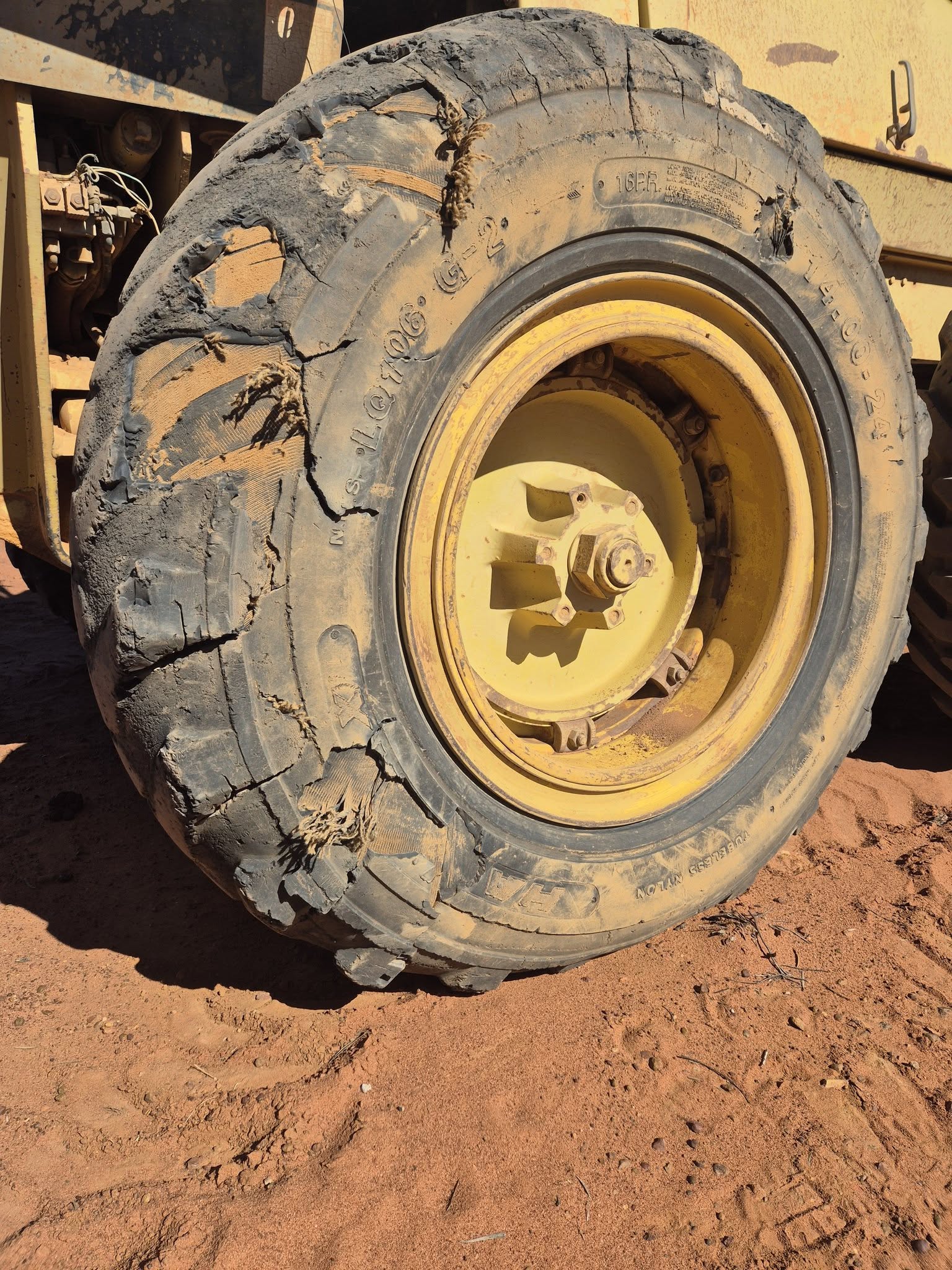 Severely damaged grader tyre still holding air