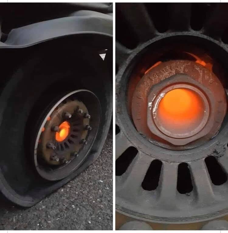 Vehicle wheel hub glowing red from extreme heat