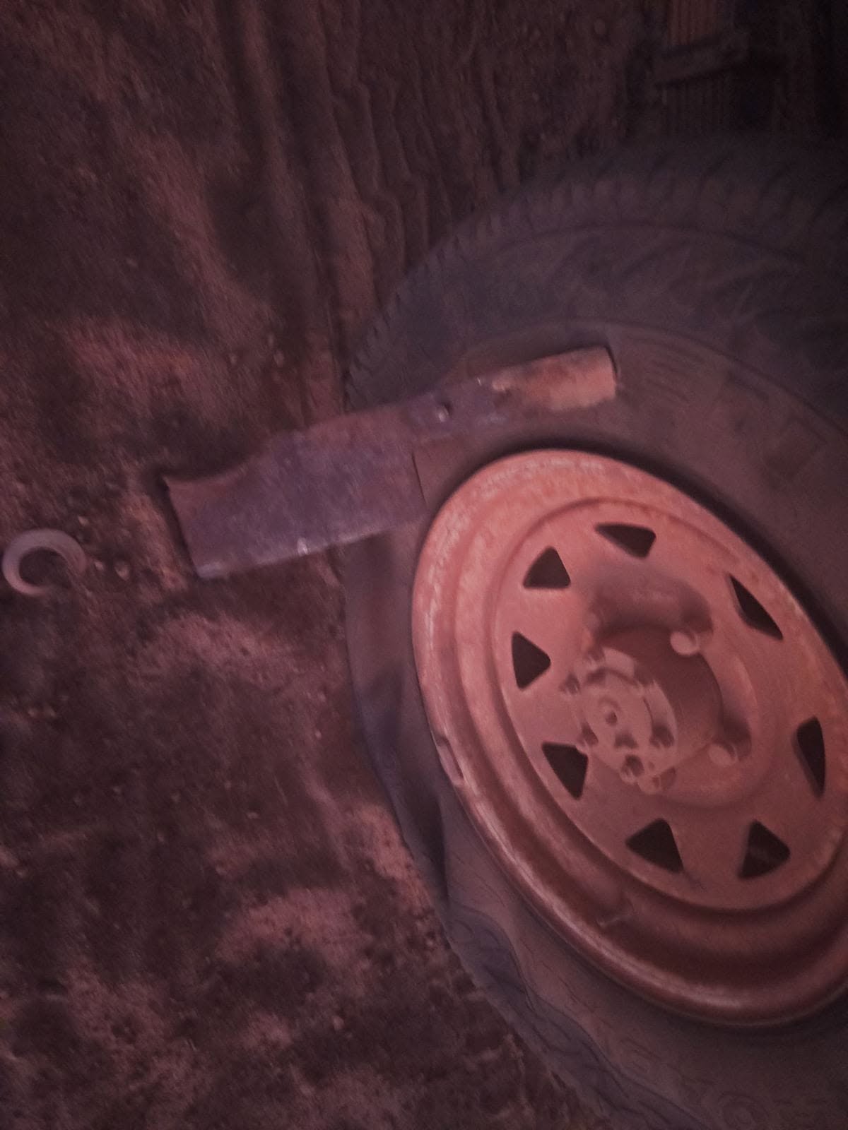 Meat cleaver embedded in a vehicle tyre