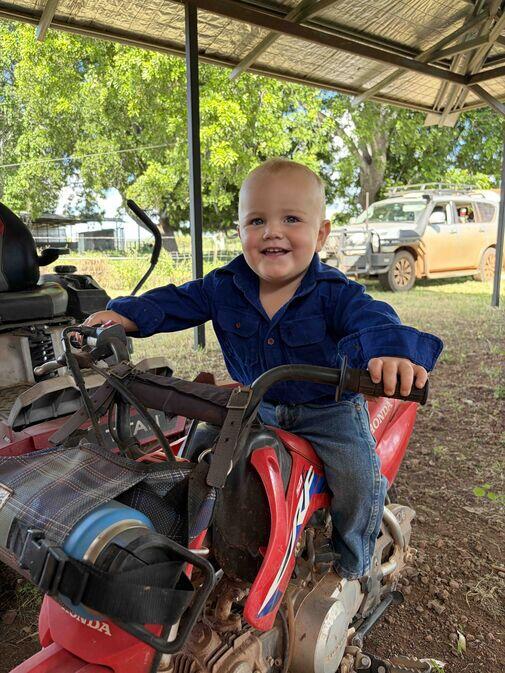 Holly Gorroick taking a child around a Northern Territory cattle station by motorbike