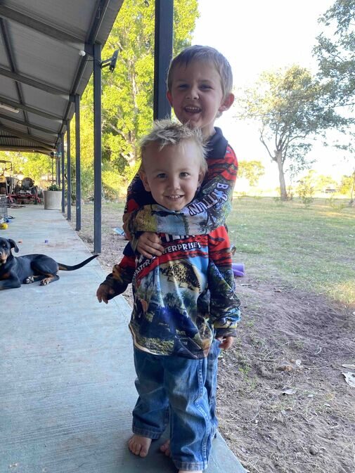 Children learning and playing on the verandah of a remote station homestead