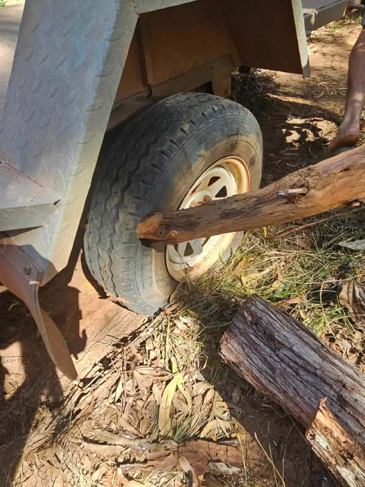 Large timber stake driven through a trailer tyre